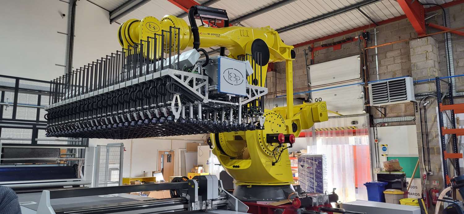 Large yellow manufacturing robot in a warehouse