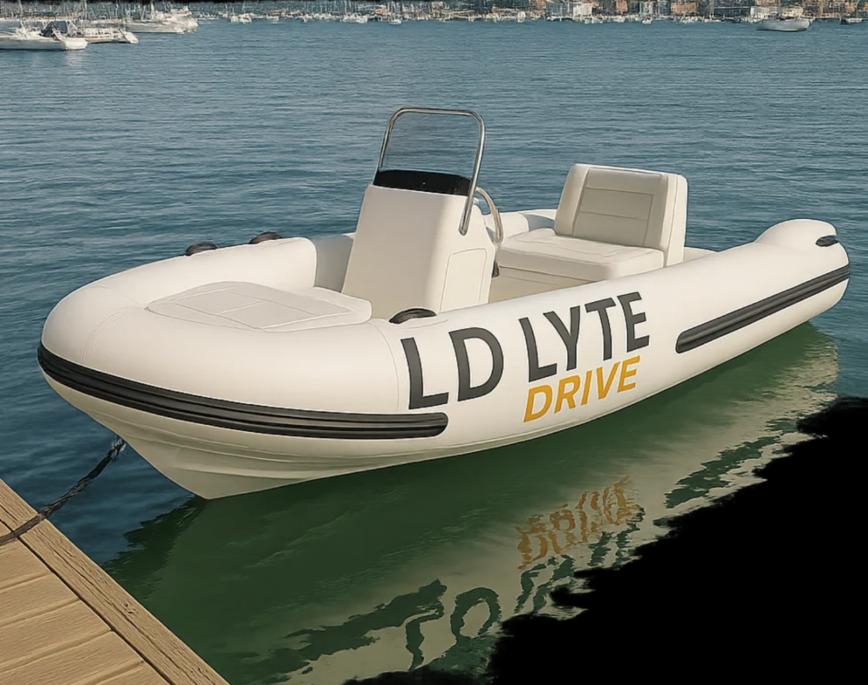 A small white inflatable boat with 'LD LYTE DRIVE' written on the side, floating near a dock on calm water.
