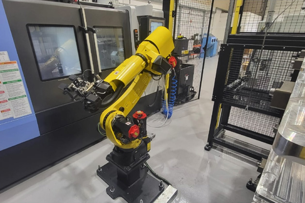 Large yellow manufacturing robot in a warehouse