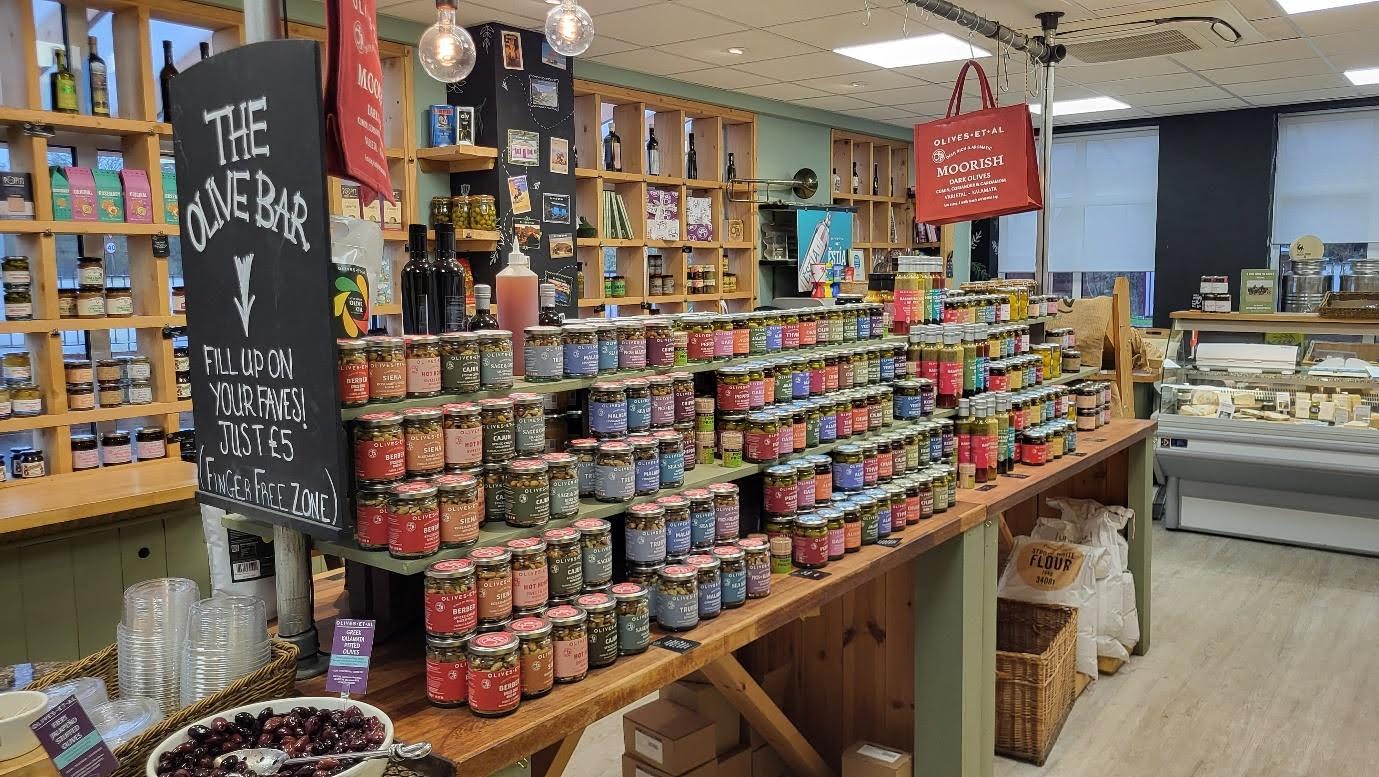photograph of containers of olives in a shop
