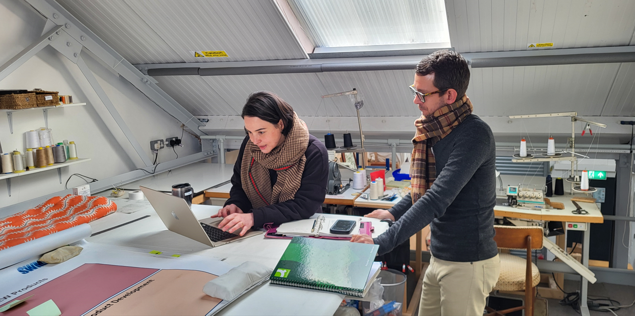 Male and female looking at samples in a furniture store