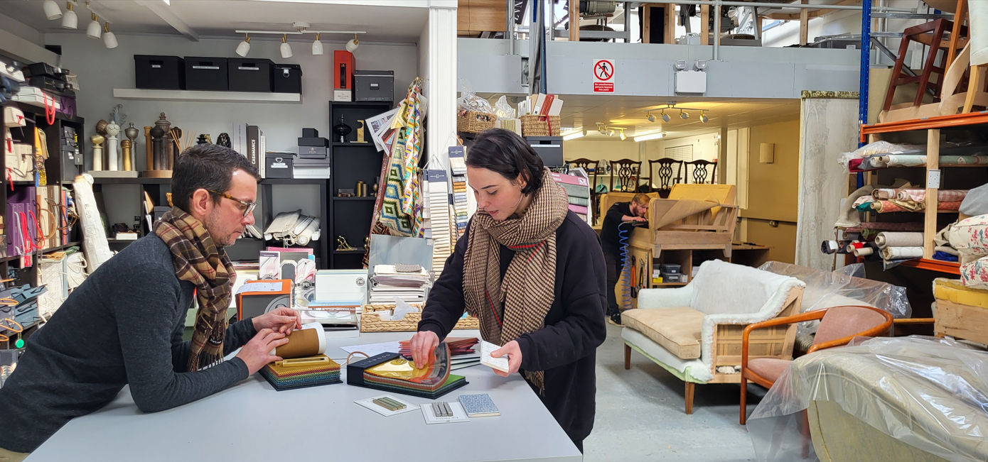Male and female looking at samples in a furniture store